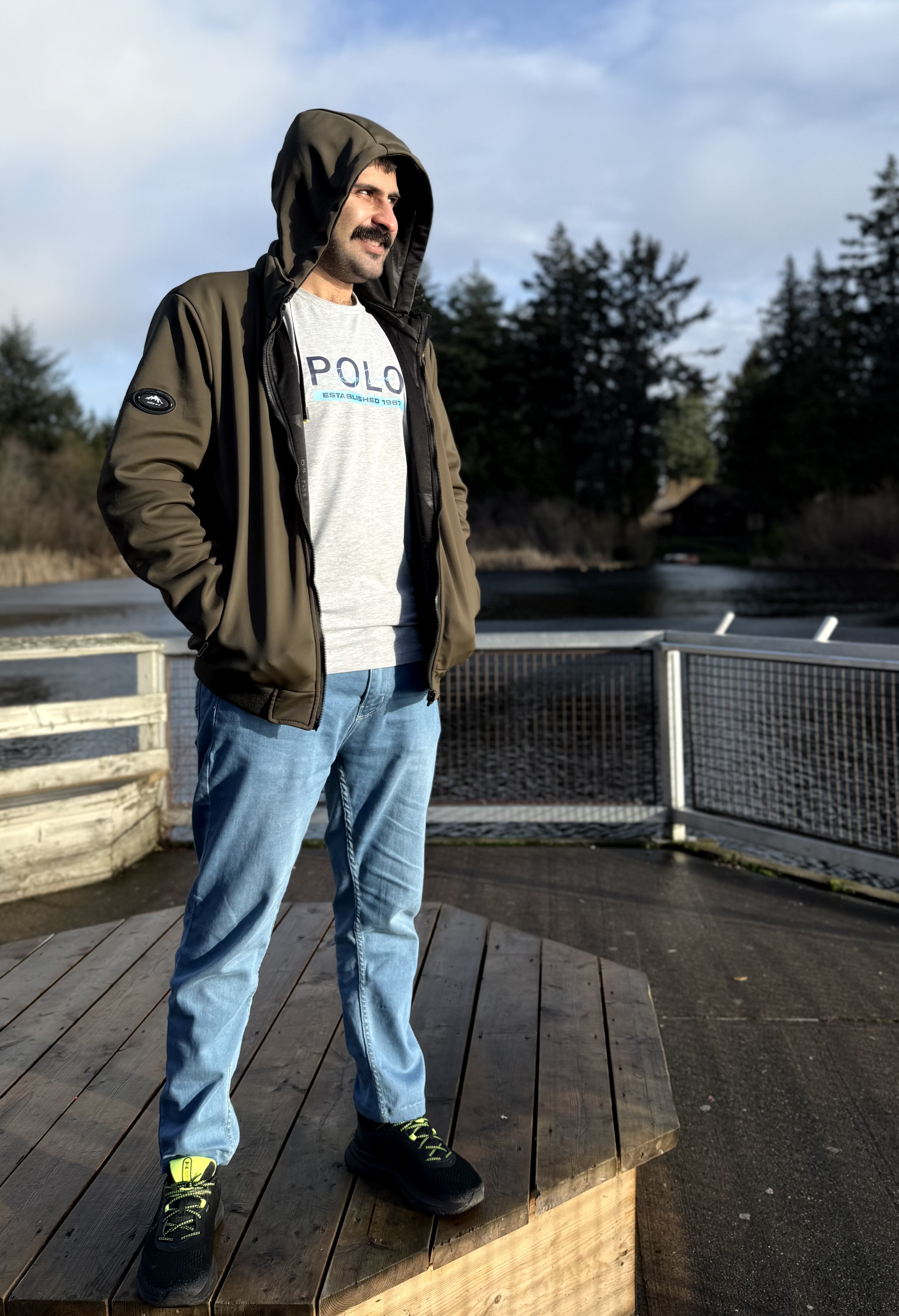 Salman Haider standing near water and trees