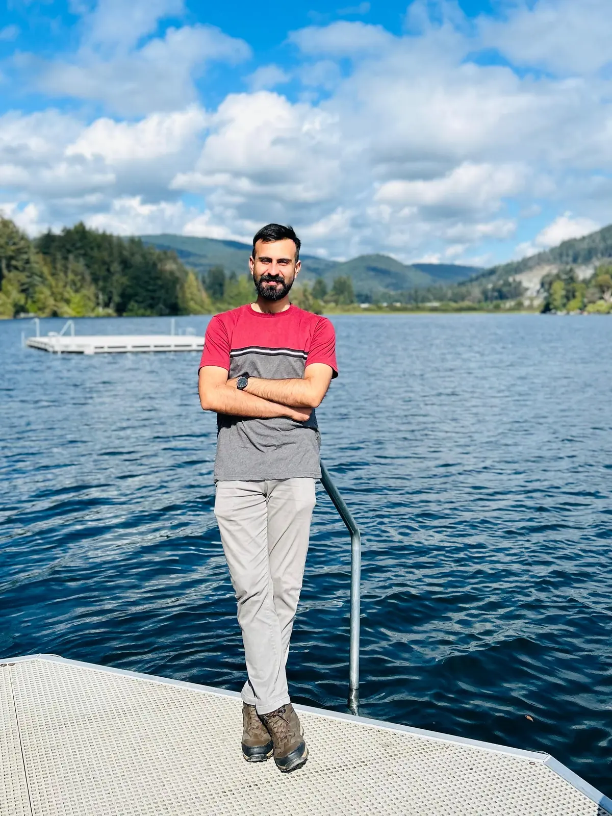 Salman Haider standing near a lake with mountains in the background