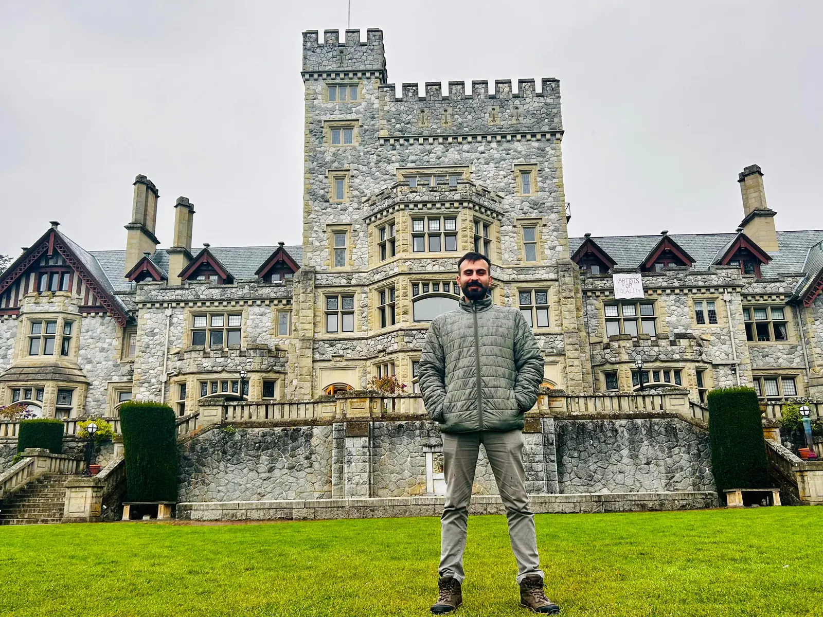 Salman Haider standing in front of a castle-style stone building