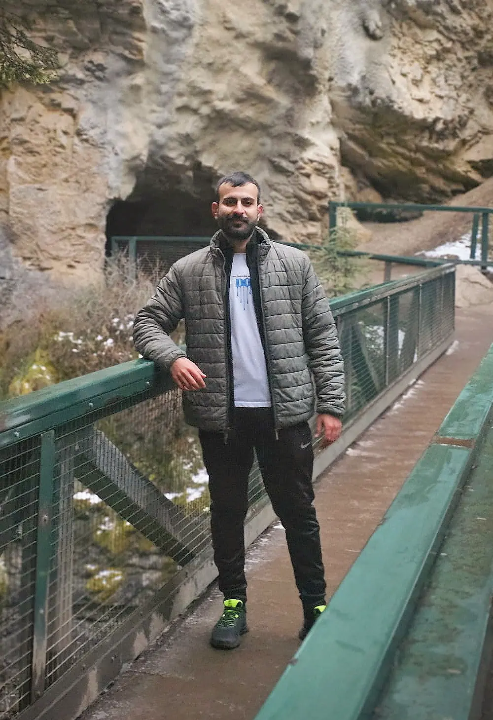 Salman Haider standing on a walkway near rock formations