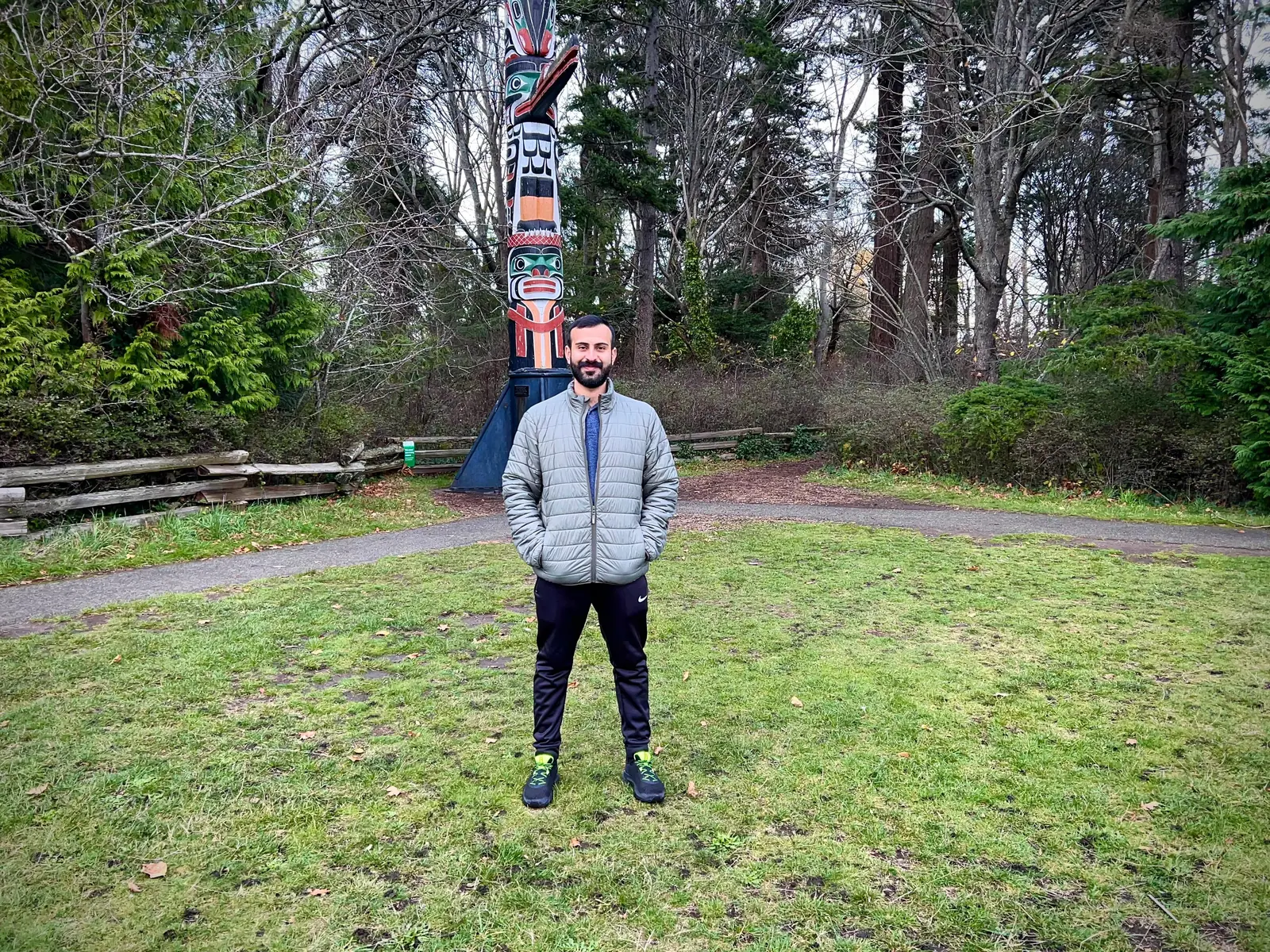 Salman Haider standing near a totem pole in a park