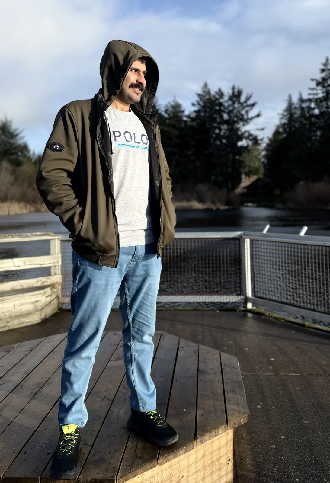 Salman Haider standing near water and trees