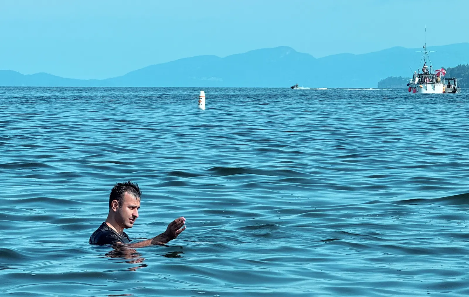 Salman Haider swimming in blue ocean water