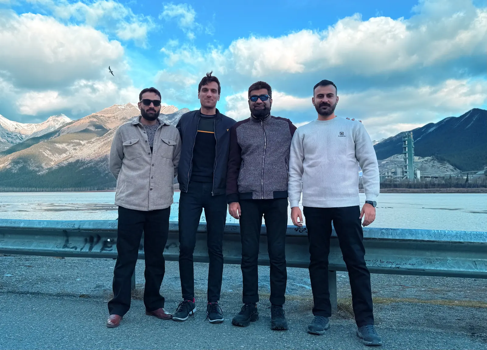 Group photo with mountains and water in the background