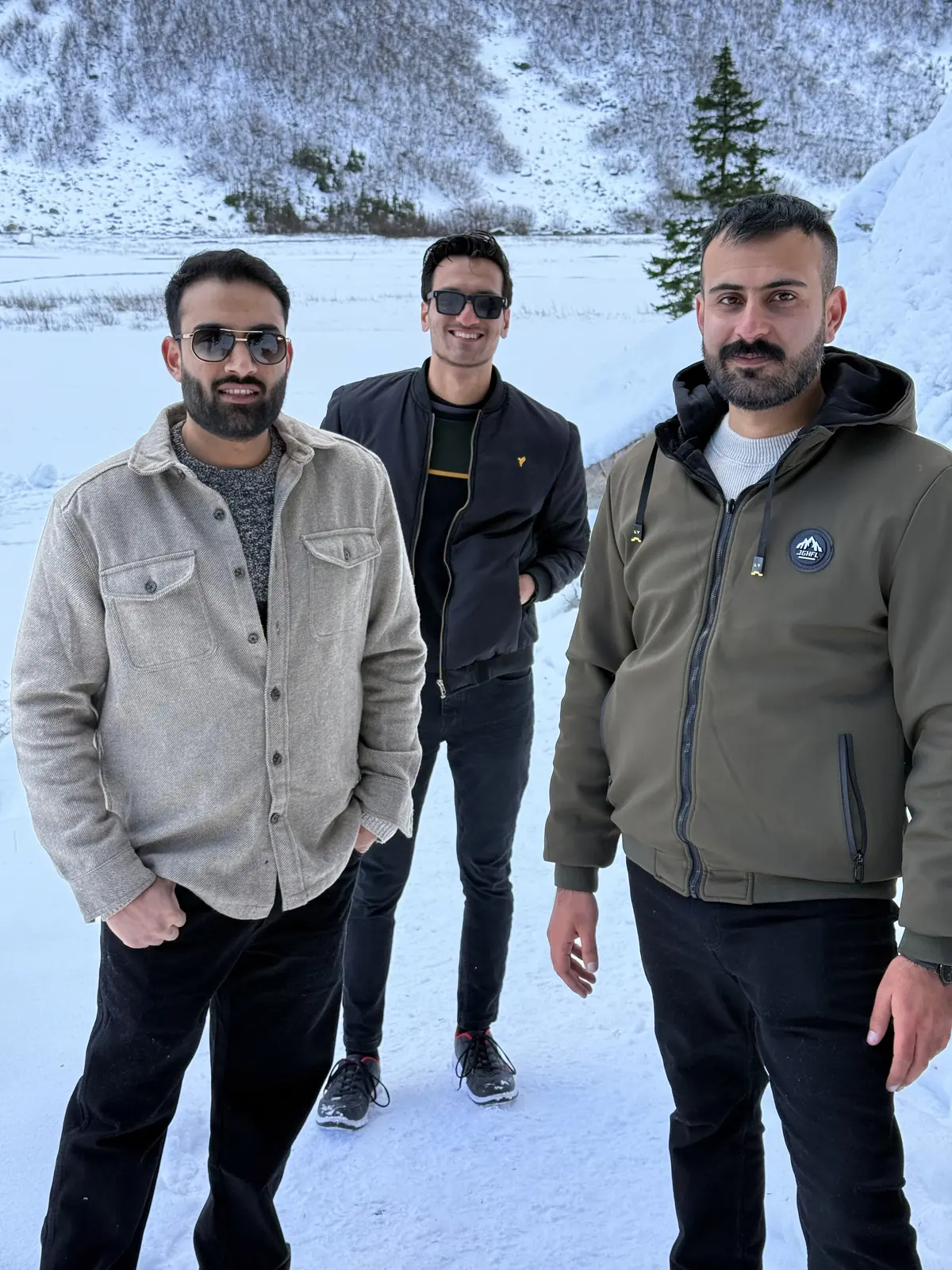 Group selfie in a snowy mountain landscape