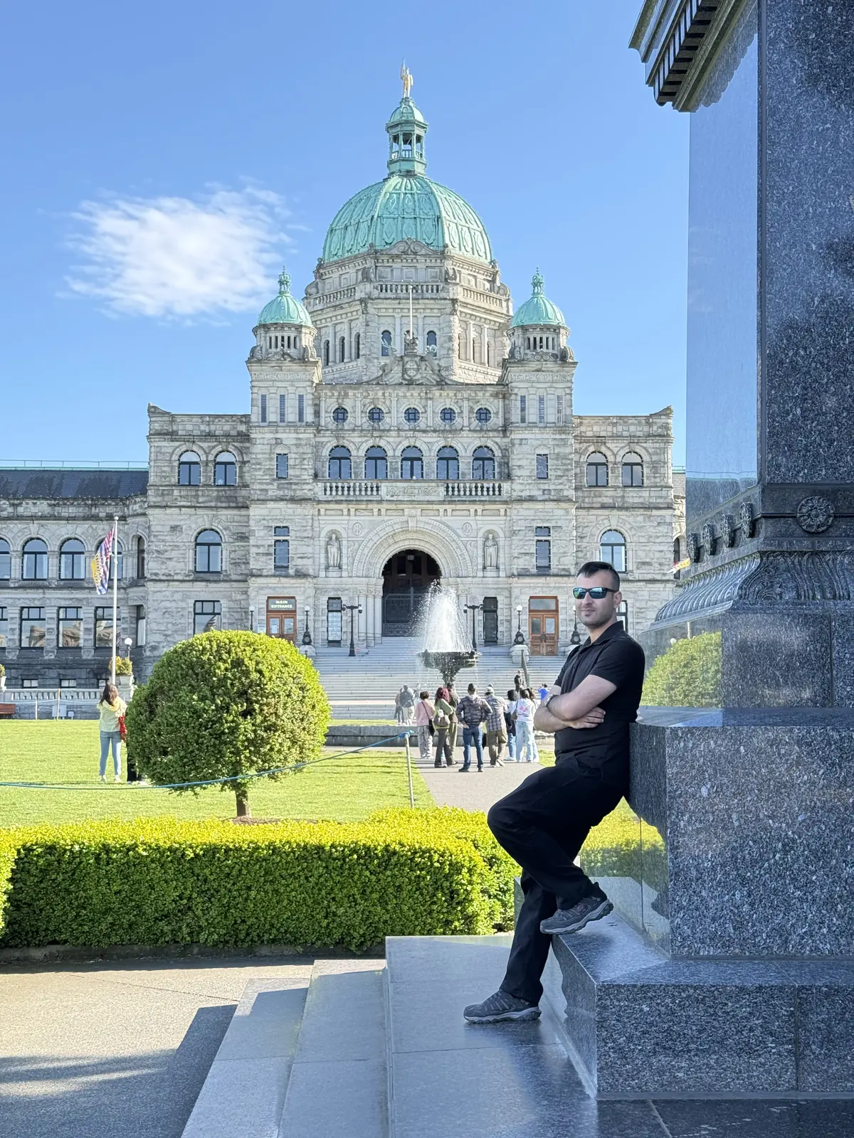 Salman Haider sitting near the British Columbia Parliament Buildings