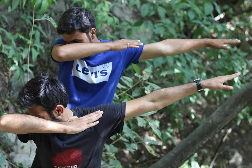 Two people posing outdoors on a hiking trail
